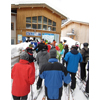Skiers wait in the lift line at the Zug 
                        chairlift in the Arlberg