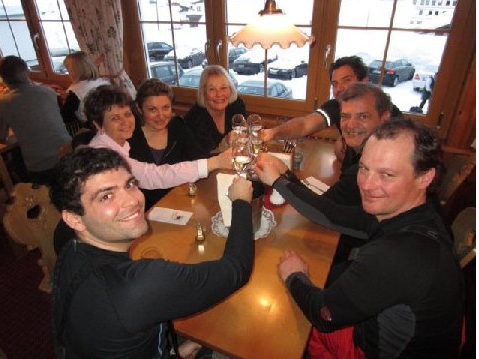 Skiers celebrate with their mountain guide at the end of their ski day in a local Austrian Stube.