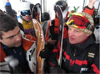 Austrian Mountain Guides talks with his clients aboard a cable car to discuss their next ski descent.